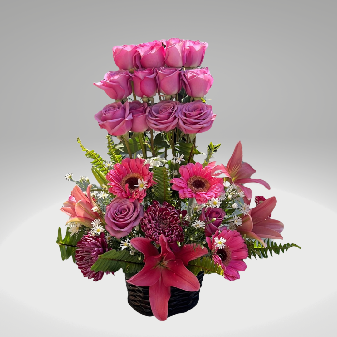 Arreglo floral alto con rosas y lirios entregado como sorpresa en un ambiente familiar en Bogotá.