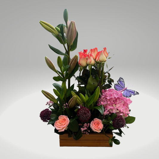 Arreglo floral vertical con rosas y lirios, diseño elegante y estructurado en Bogotá
